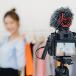 Camera recording a female influencer during a fashion shoot, representing the work of an Influencer Agency.