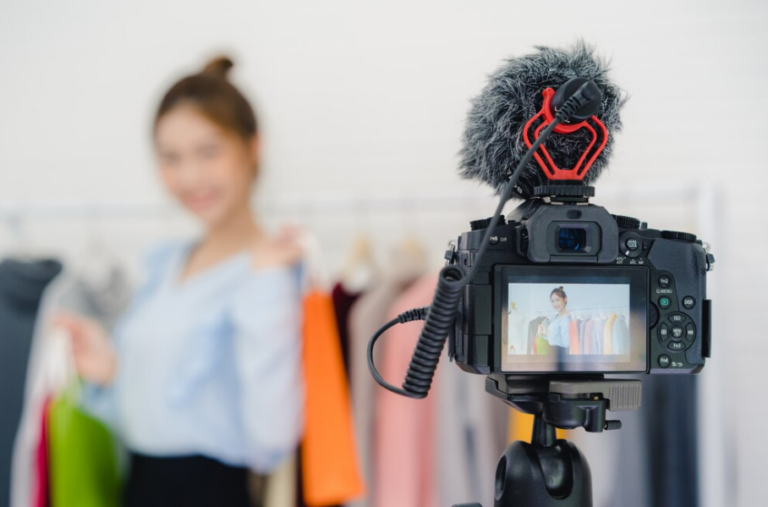 Camera recording a female influencer during a fashion shoot, representing the work of an Influencer Agency.