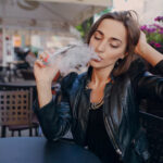 adult-touching-her-head-while-smoking_1157-448