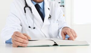 Healthcare credentialing specialist verifying physician qualifications for compliance and insurance enrollment