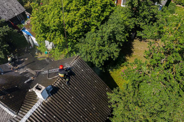 firefighter-sits-roof-burning-house_151992-1382