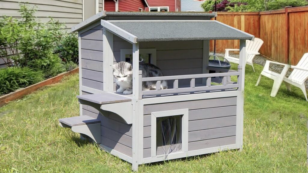 A cat sits atop a heated outdoor cat house, showcasing a cozy and inviting space for feline relaxation.