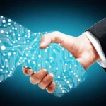 A hand holding a glowing, blue, circuit board-patterned shape that symbolizes digital transformation or technology