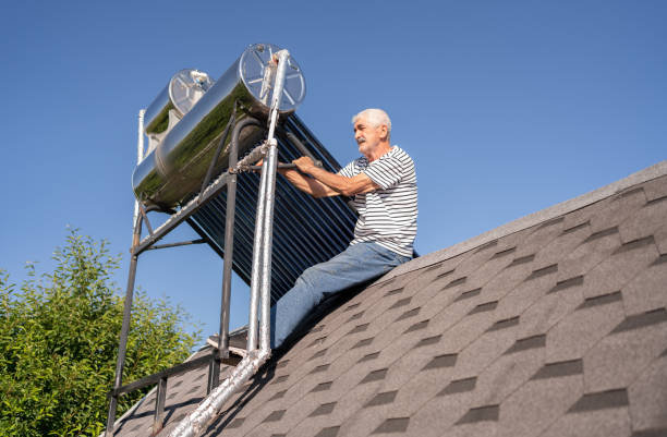 Senior Man Installing Solar Water Heater Panels On The Roof