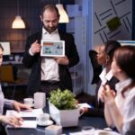 focused-businessman-showing-corporate-graphs-presentation-using-tablet-working-company-ideas (2)