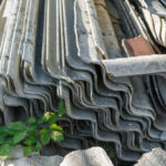 Asbestos roof removal . Asbestos dust in the environment. Health problems