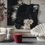 Customer exploring a quality furniture showroom, checking sofa comfort, solid wood construction, fabric texture, and craftsmanship for long-term home value.