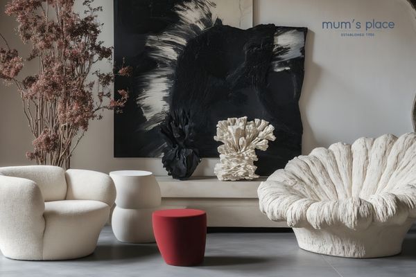 Customer exploring a quality furniture showroom, checking sofa comfort, solid wood construction, fabric texture, and craftsmanship for long-term home value.