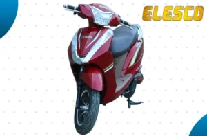 Red ELESCO electric scooter with white graphics, black seat, alloy wheels, and front headlight, displayed against a light dotted background.