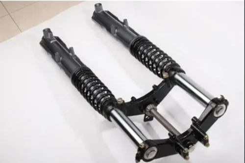Pair of black and silver front suspension shock absorbers with coil springs, connected by a metal linkage, placed on a white surface.