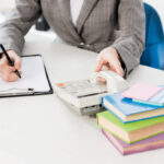 cropped image of businesswoman answering stationary telephone in office