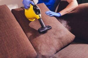 dry-cleaner-s-employee-removing-dirt-from-furniture-flat-closeup_152904-2668