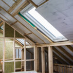 A professional construction site showing timber framing and insulation installed by Loft Conversion Specialists in Harrow UK.