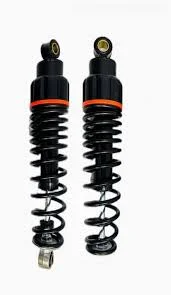 Electric bike front suspension shock absorbers with black coil springs and red ring design on white background