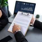 man-signing-contract-desk_31965-98122