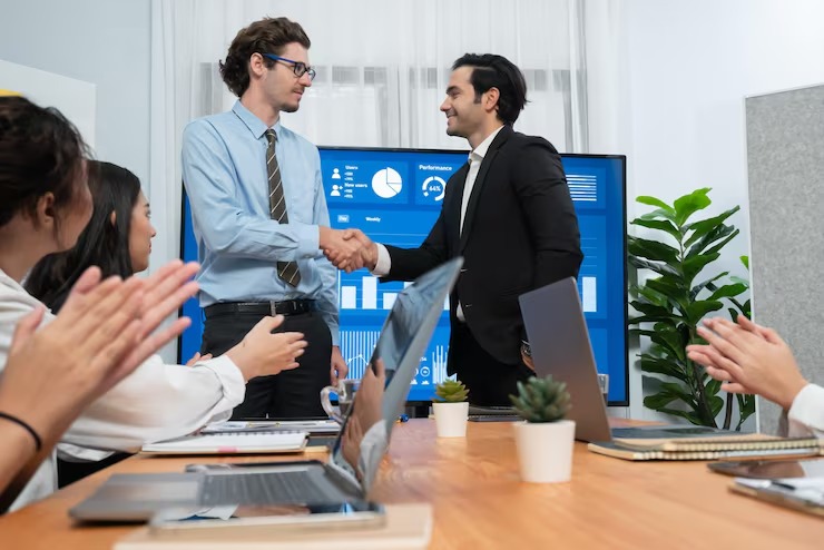 imgi_6_two-businessman-shake-hand-meeting-room-with-cheerful-colleagues-habiliment_31965-364880