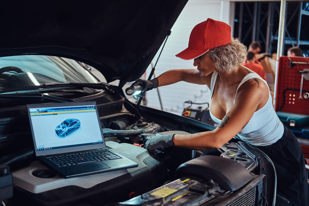 Technician using the iCarsoft VAWS V4.0 diagnostic tool to scan a Volkswagen vehicle for faults