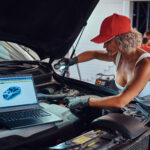 Technician using the iCarsoft VAWS V4.0 diagnostic tool to scan a Volkswagen vehicle for faults