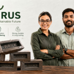 Angirus founders standing behind stacked Wricks made from recycled plastic and industrial waste