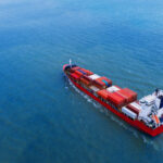 Aerial view of container cargo ship in sea.