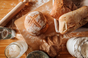 Sourdough bread with ingredients and utensils on the table.